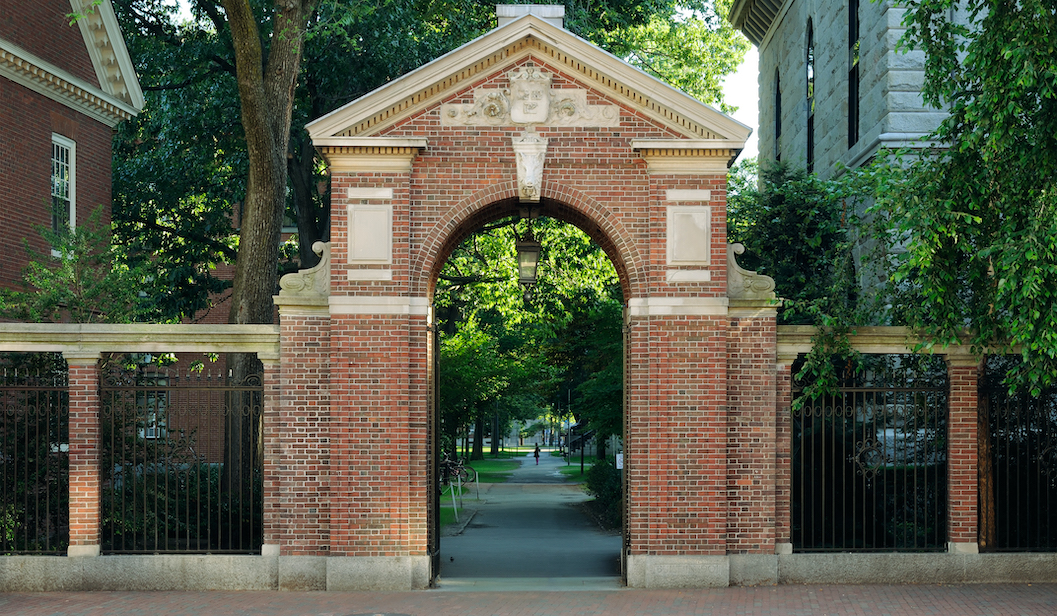 Harvard's gate to a prestigious university campus surrounded by trees