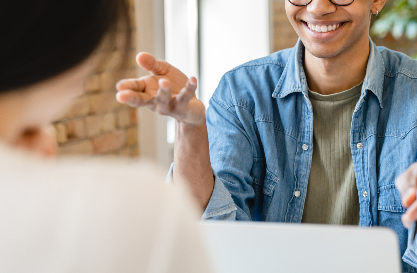 A student being interviewed, seated across from an interviewer