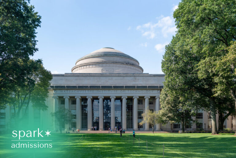 Iconic university building with grand columns and a domed roof overlooking a green campus lawn.