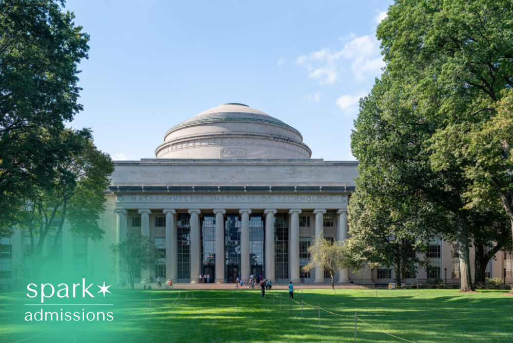 Iconic university building with grand columns and a domed roof overlooking a green campus lawn.