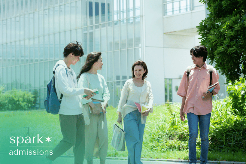 Group of college students smiling and discussing admissions