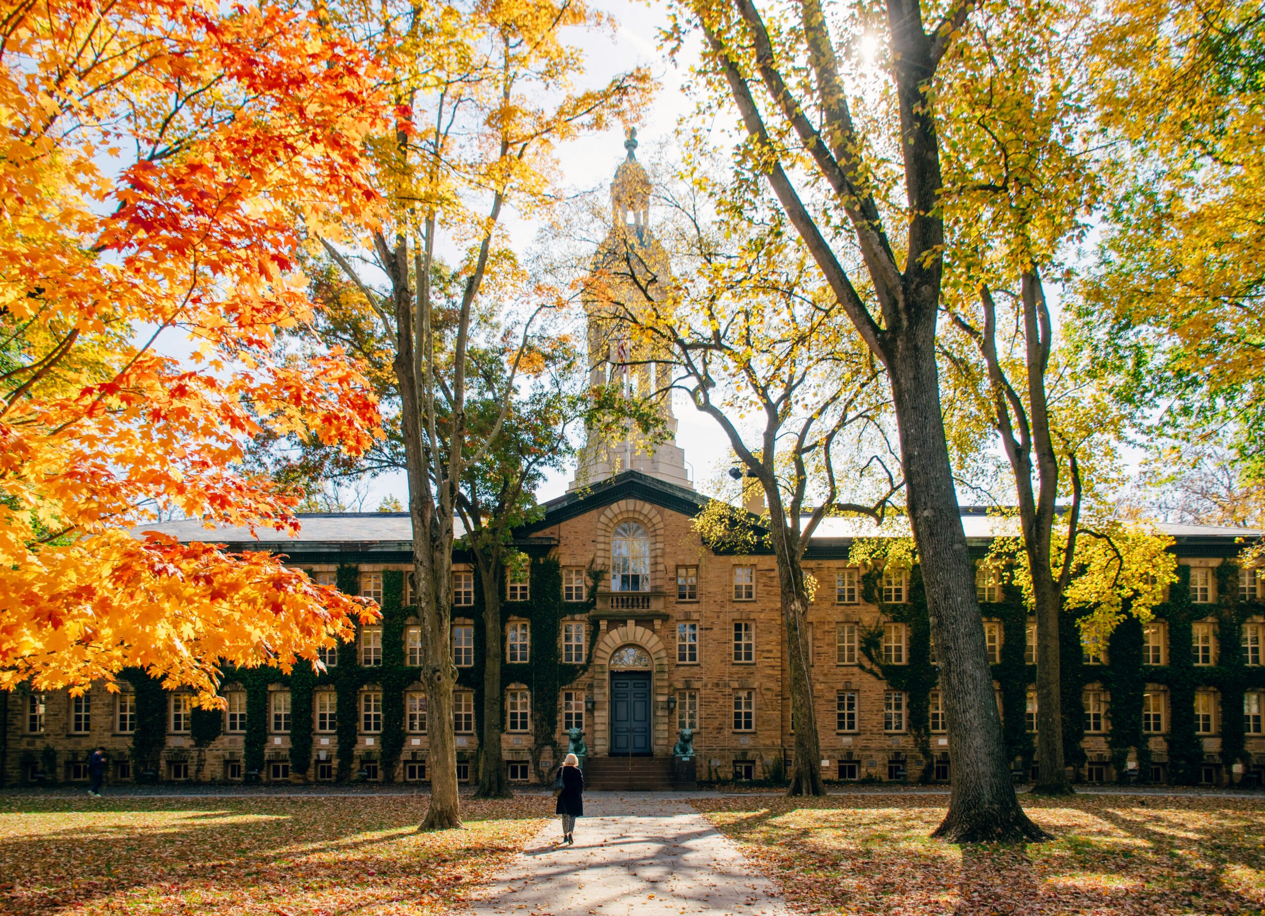 Graphic showing Princeton’s low acceptance rate with a student looking up at a college building