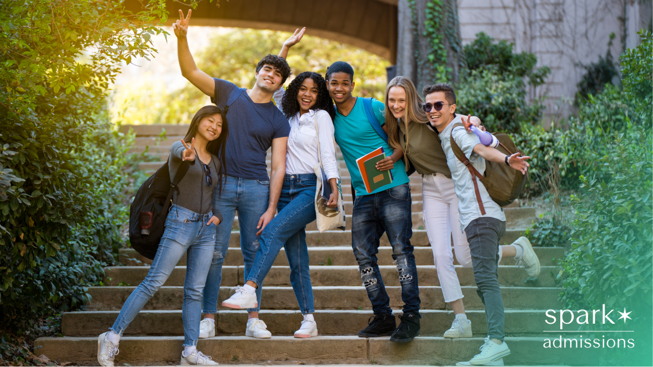 Group of diverse college students smiling and posing together on outdoor steps
