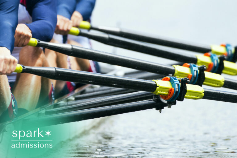 College rowing team training on the water, with athletes pulling oars in sync during a competitive crew practice or university rowing event.