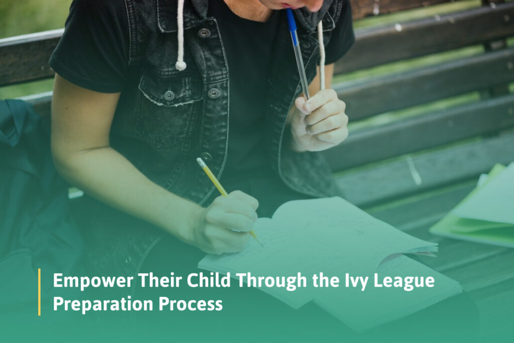 A student sits on a bench writing in a notebook while holding a pen in their mouth