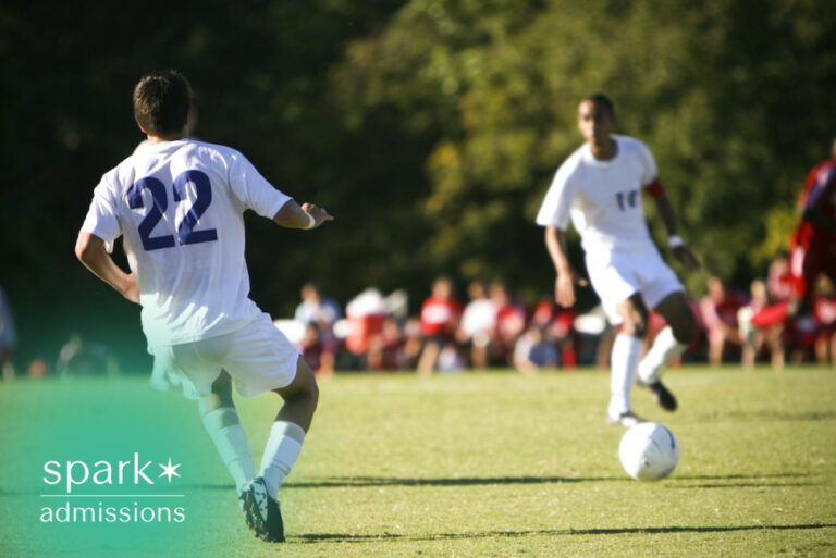 College soccer players competing during a match on an outdoor field, highlighting collegiate athletics, teamwork, and student-athlete competition.