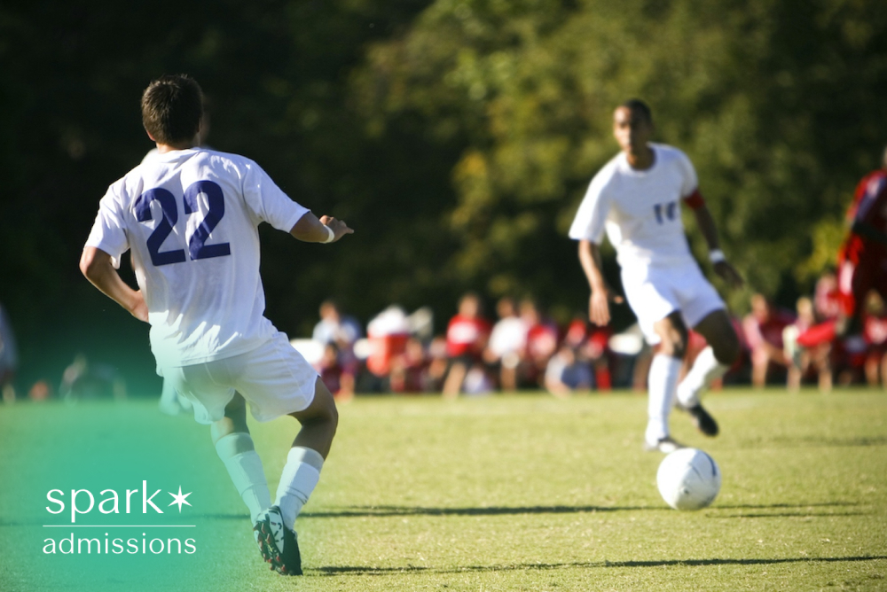 College soccer players competing during a match on an outdoor field, highlighting collegiate athletics, teamwork, and student-athlete competition.