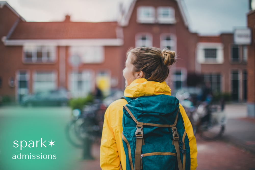 Prospective college student wearing a backpack while exploring a university campus during a self-guided campus visit, showcasing college life and student experience.