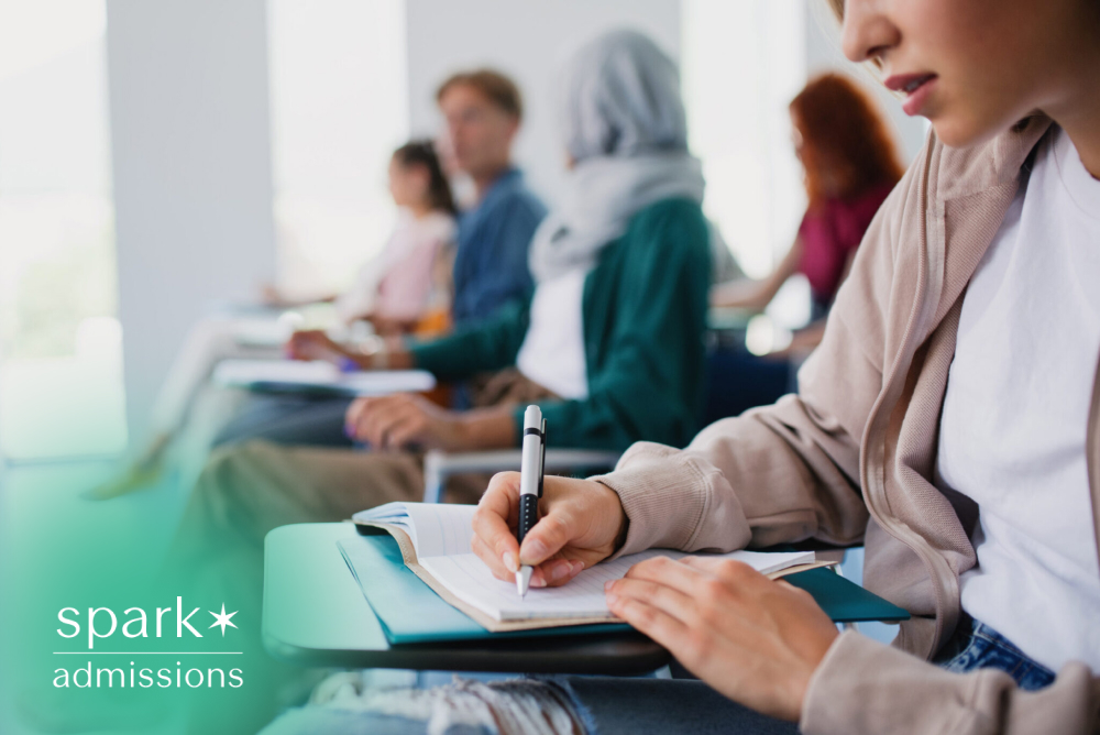 Diverse college students taking notes during a classroom lecture in a modern university learning environment.