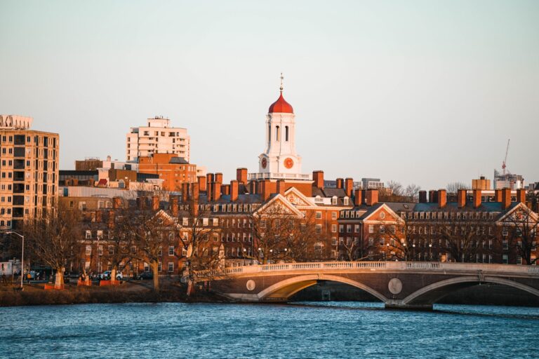 Cityscape of Harvard University with its iconic red dome viewed from across the river