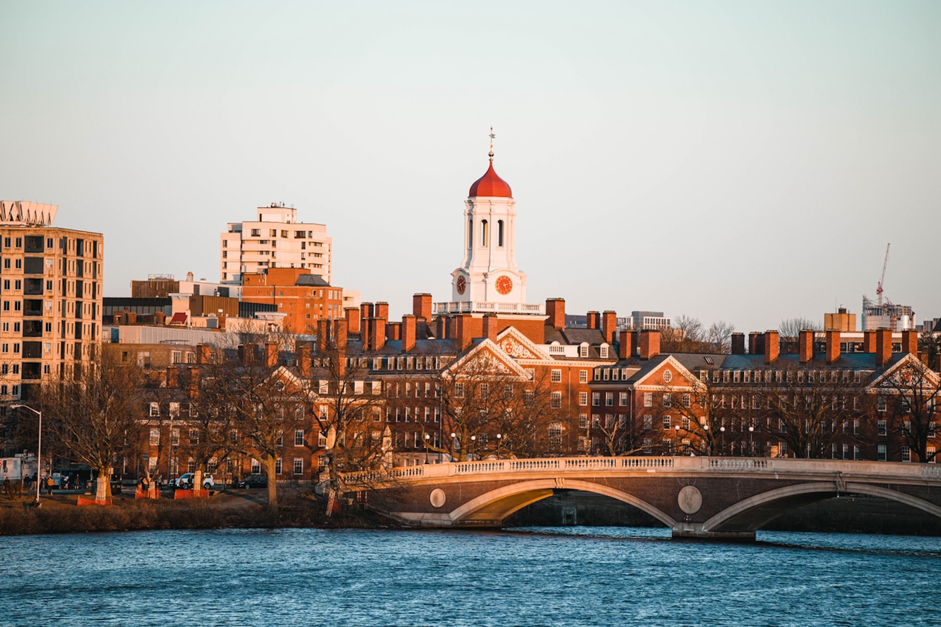 Cityscape of Harvard University with its iconic red dome viewed from across the river