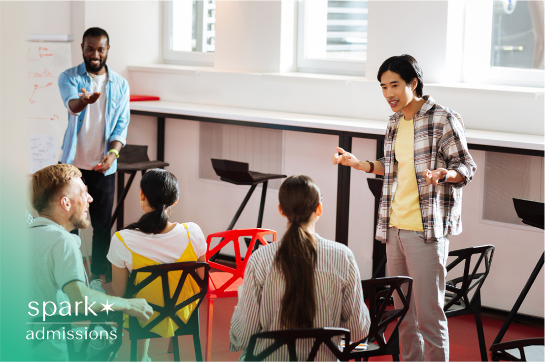 Two students presenting and leading a classroom discussion in front of peers