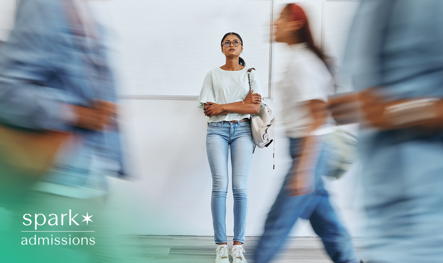Student standing still in a hallway while others walk past, representing feeling overwhelmed or unsure