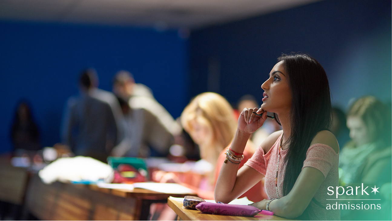 Student attentively listening in a classroom with peers in the background