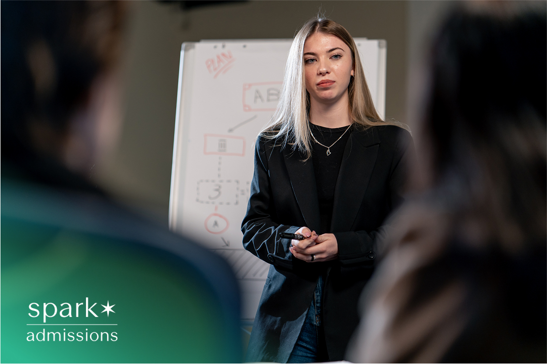 Focused woman centered in frame, engaged in discussion in a professional setting