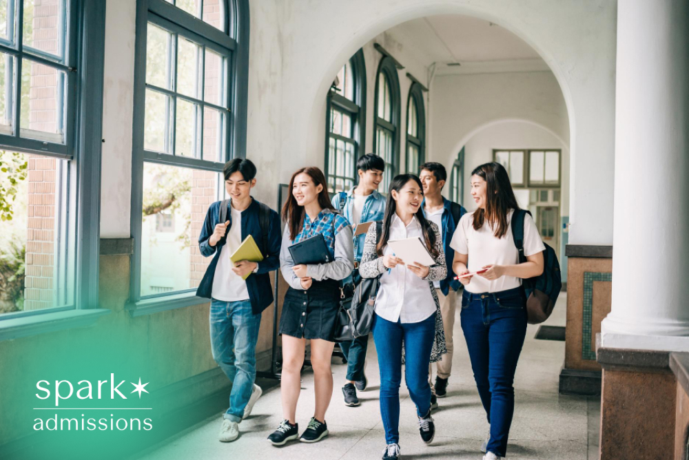 Students walking together in a university hallway with notebooks