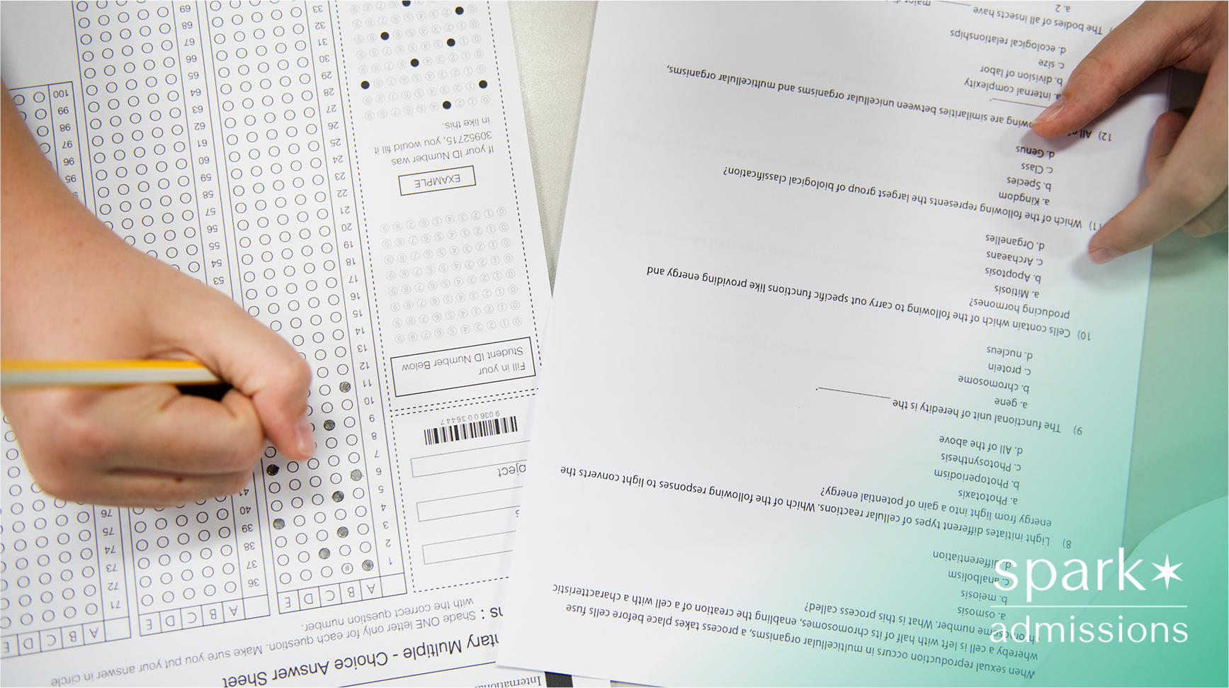 Close-up of a student filling out a multiple-choice test and a paper exam with biology questions