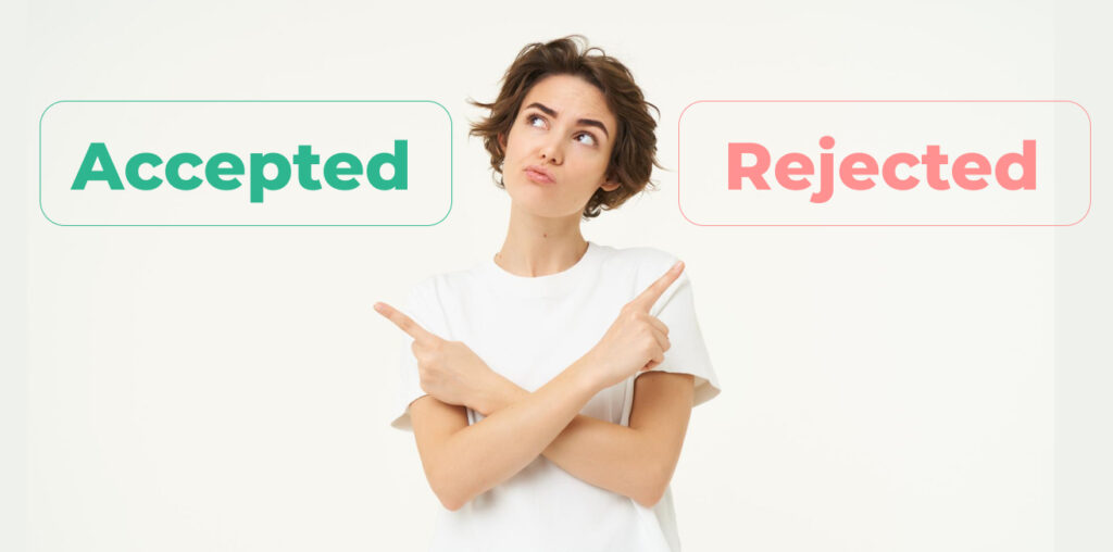 Young woman in a white shirt pointing both ways with "Accepted" and "Rejected" signs above her shoulders