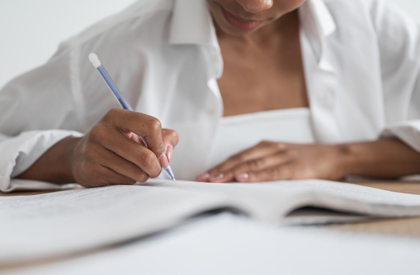 Close-up of a female student writing in a notebook