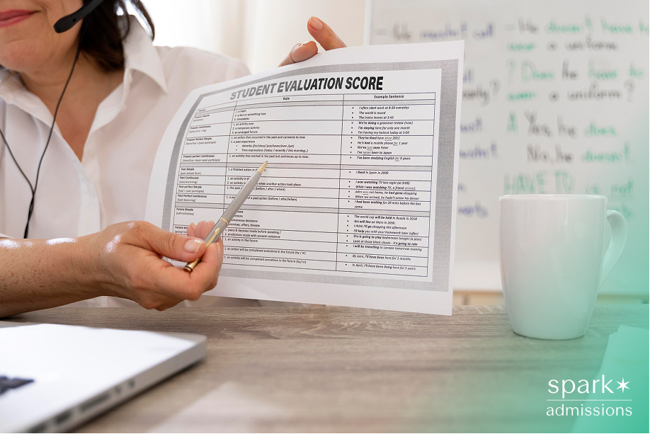 Instructor pointing to a student evaluation score sheet during an online class