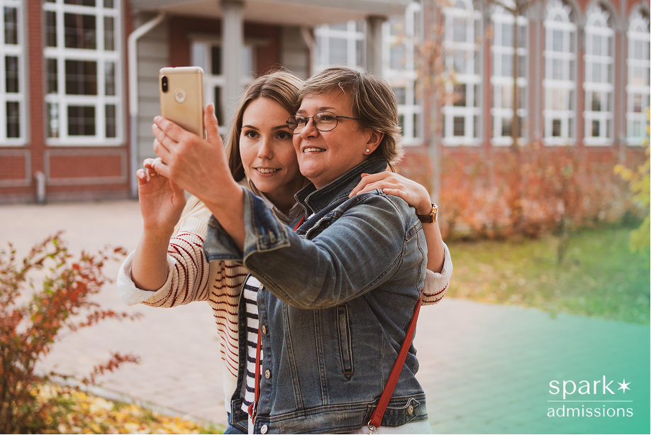 Mother and daughter taking a selfie together on a college campus