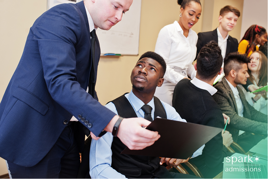 Mentor guiding a student during a networking session, showcasing relationship-building in the best extracurriculars for business majors.