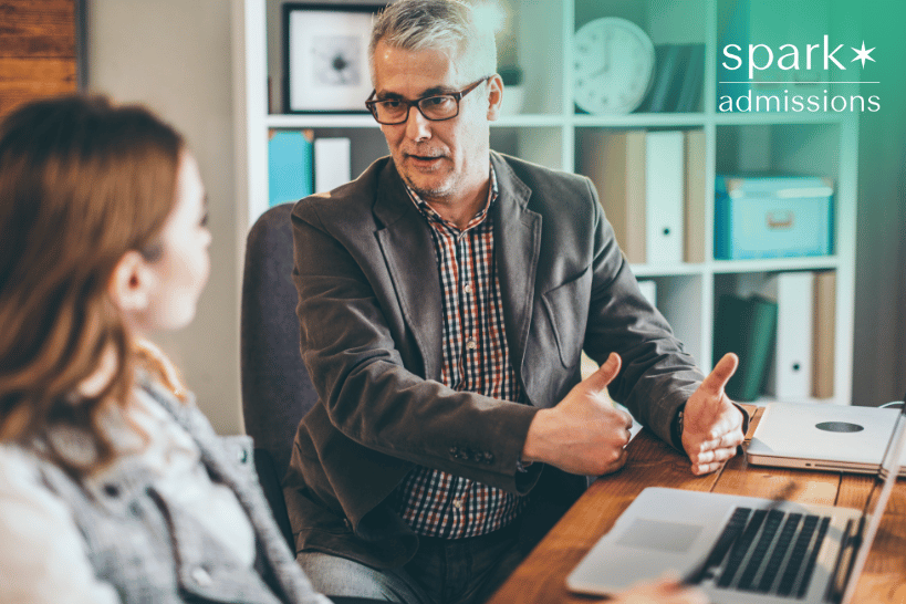 Male mentor giving feedback to student on portfolio