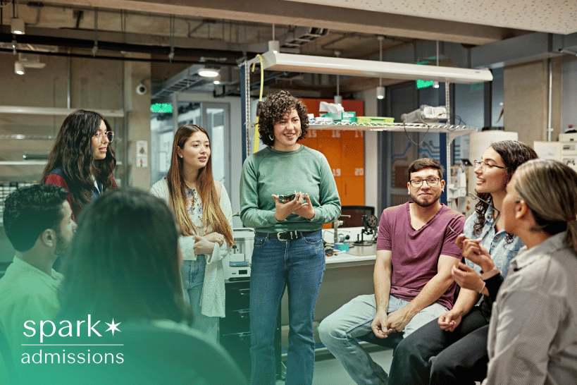 A group of diverse college students smiling and discussing together outdoors