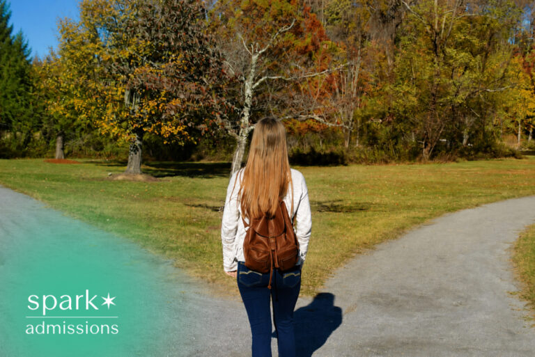 Student with backpack choosing between two paths on campus