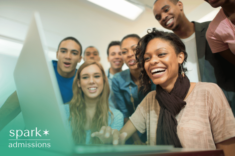 Happy student with laptop celebrating admission success with friend in background