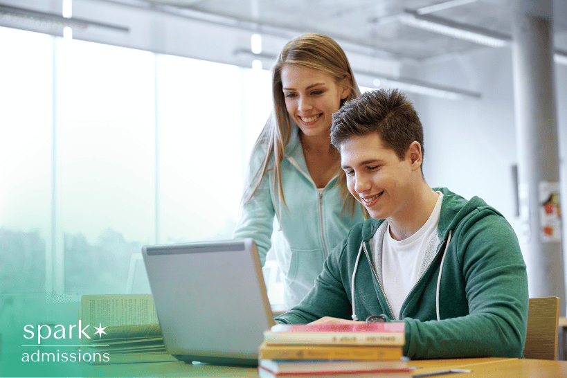 College consultant guiding male student on laptop during application review