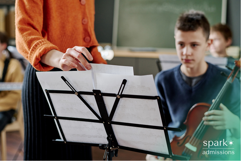 Student musician practicing with sheet music, highlighting how musical commitment impacts college admissions.
