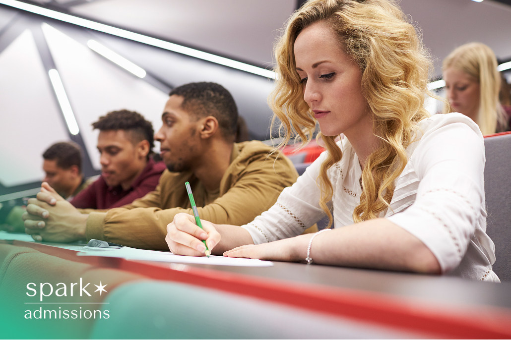 Female student taking notes in a university business lecture.