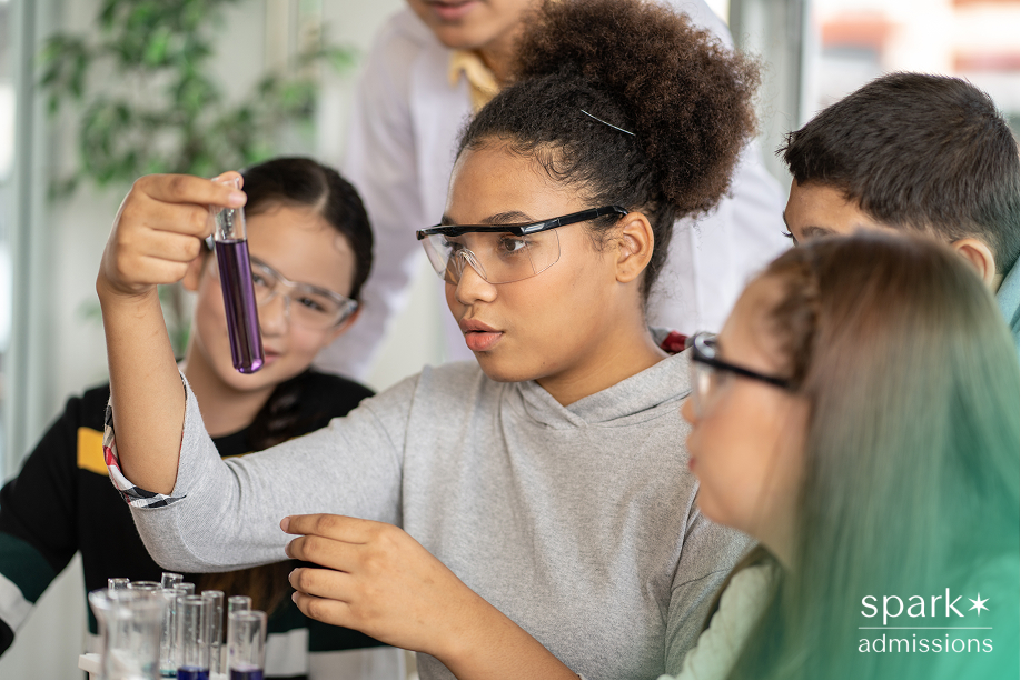 Students exploring a science experiment, reflecting summer enrichment opportunities before starting high school.