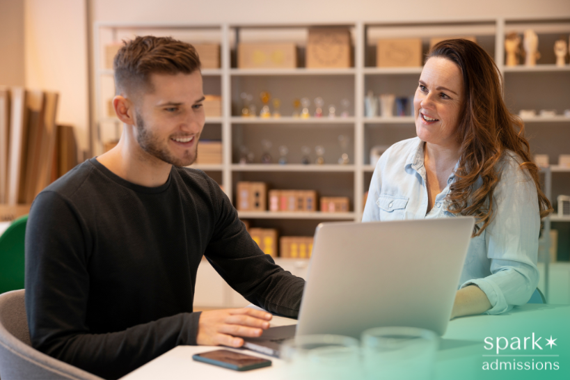 Male student meeting with a college admissions counselor for undergraduate business school guidance