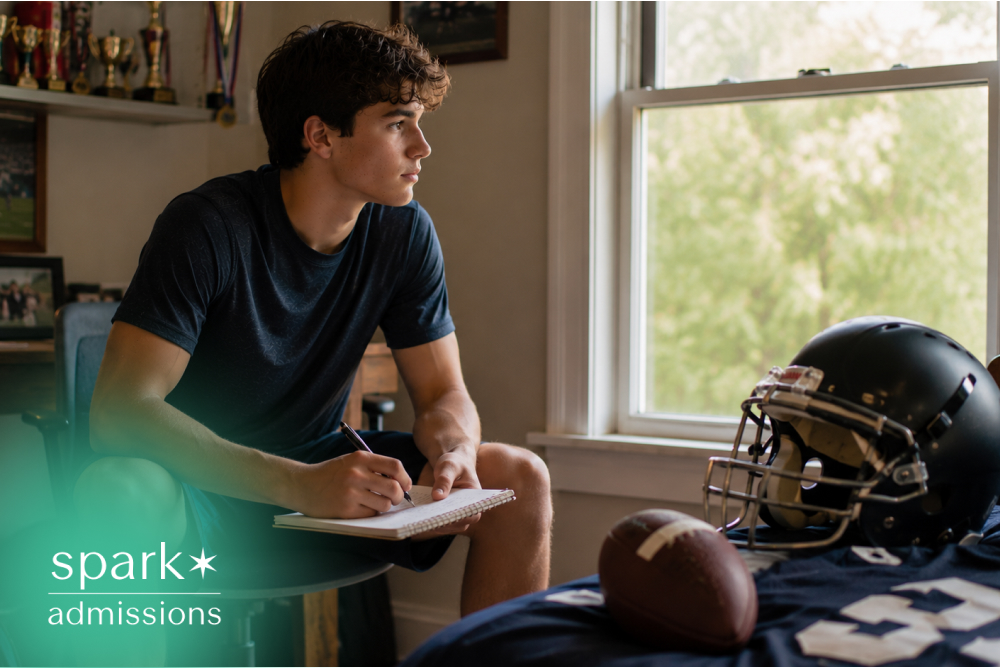 Teen athlete writing goals beside football gear in bedroom